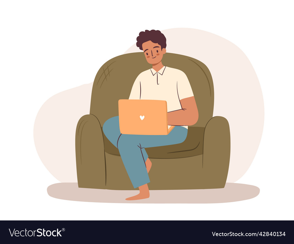 Man working on laptop in armchair