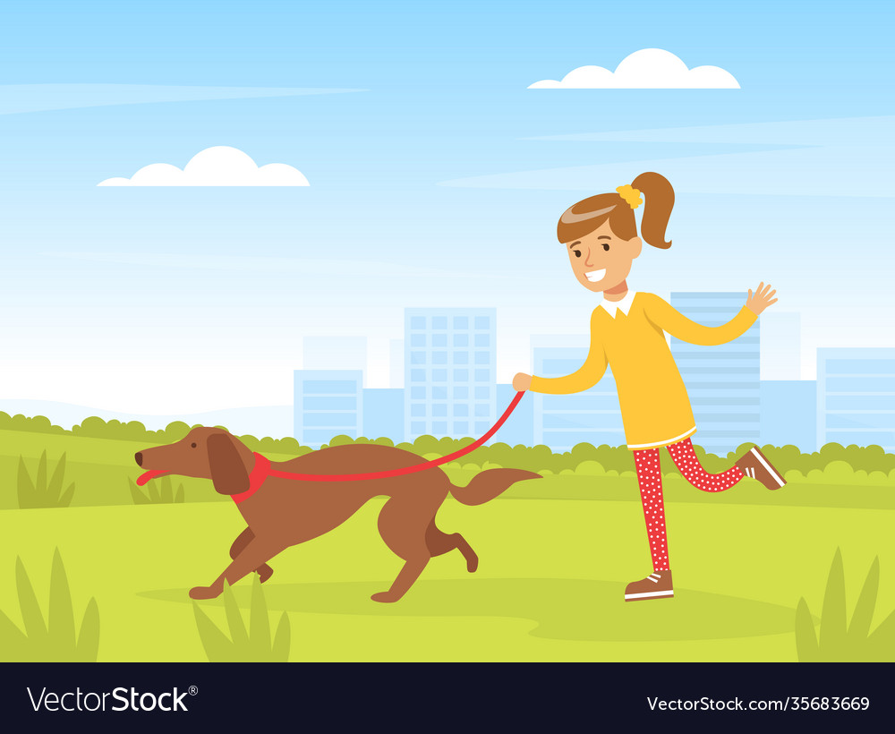 Happy girl walking with her dog outdoors kid