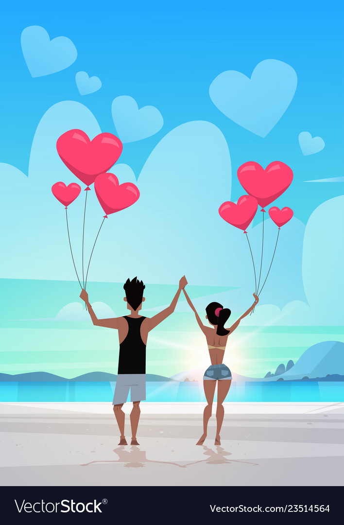 Rear view couple holding pink heart shape air