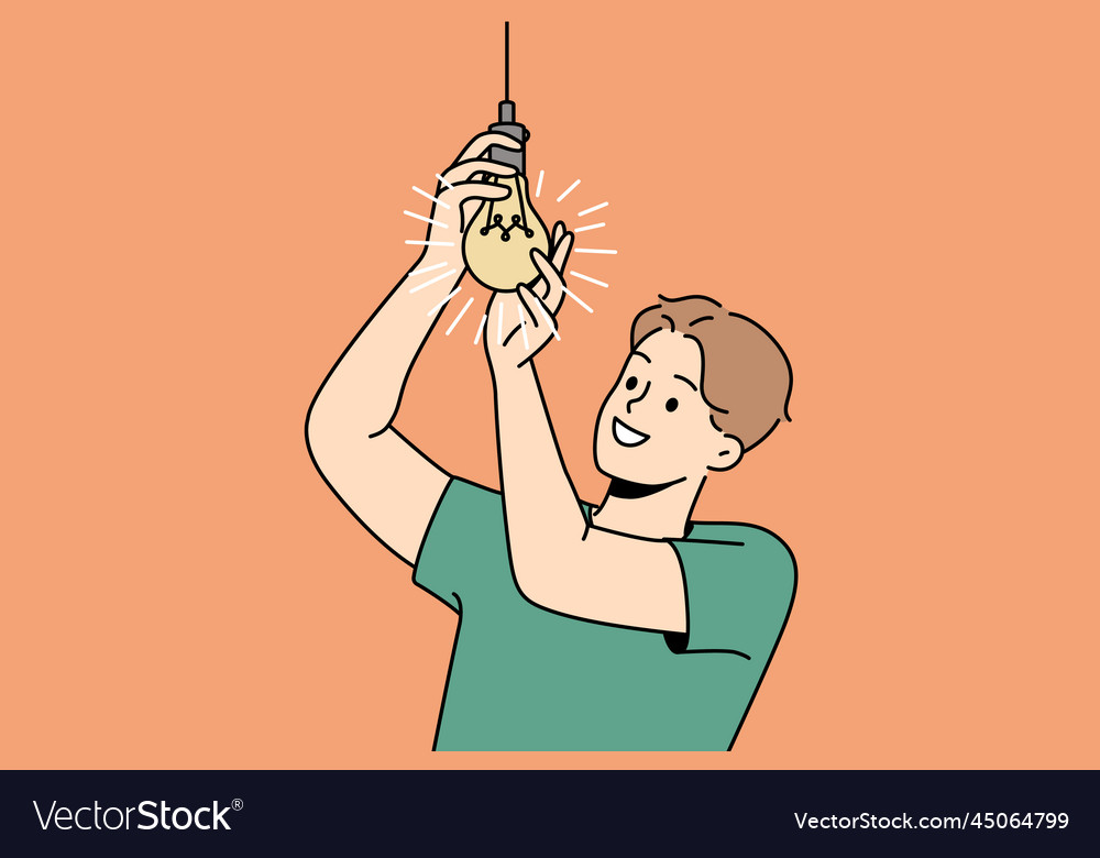 Smiling man screwing lightbulb