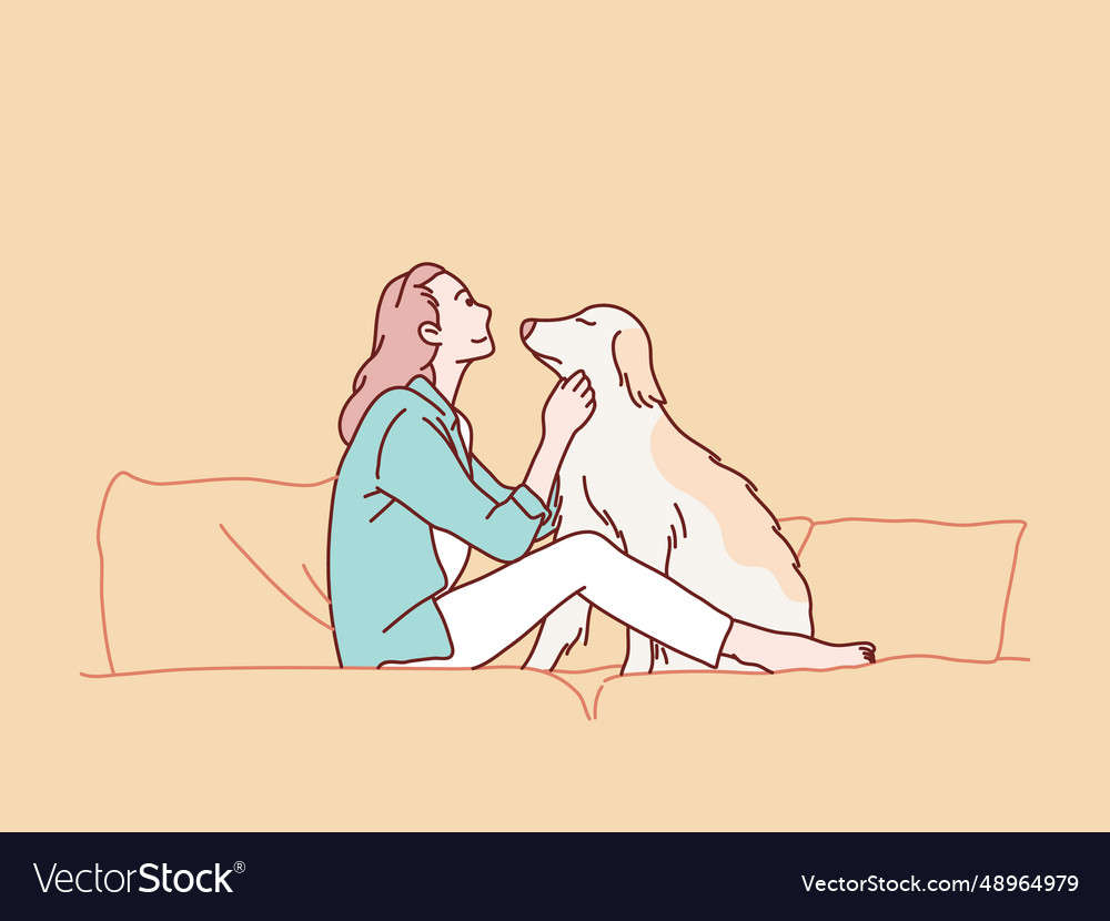 Young woman hugging her beloved dog sitting