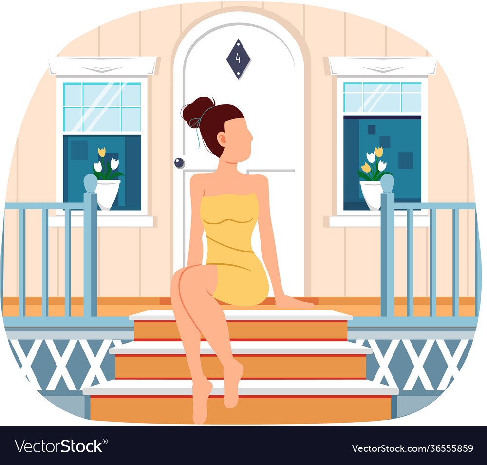 Woman wearing yellow dress sits on doorstep her