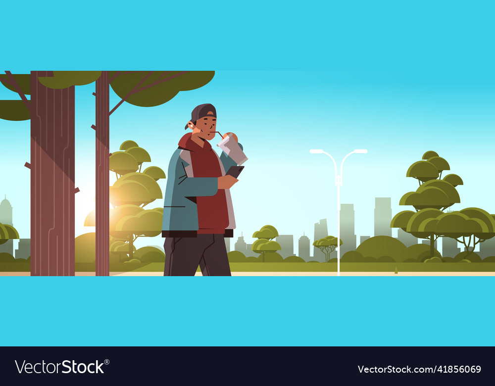 Man drinking coffee with straw and using