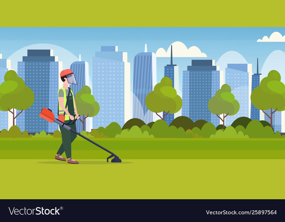 Man gardener in uniform cutting grass with brush