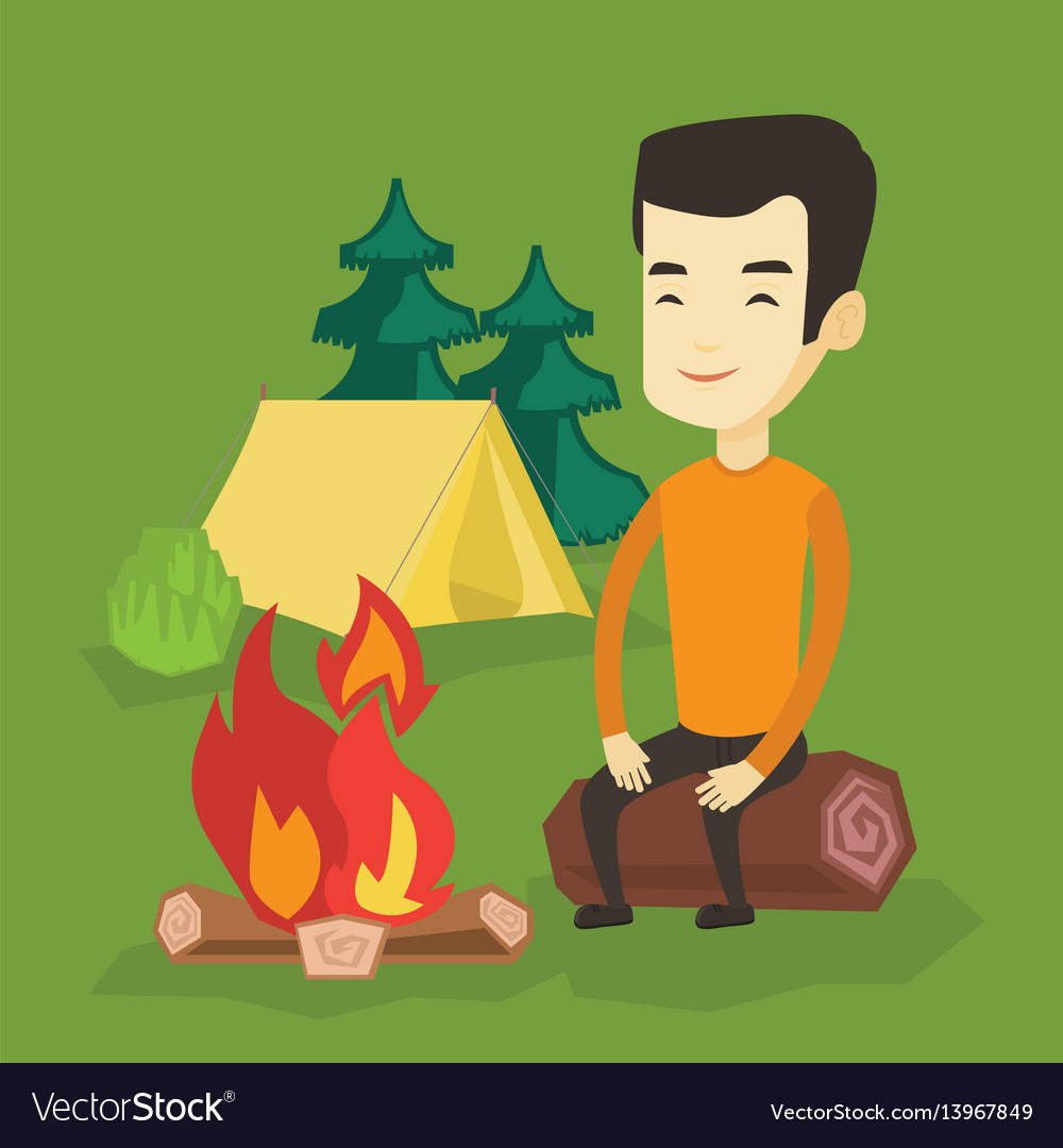 Man sitting on log near campfire in the camping