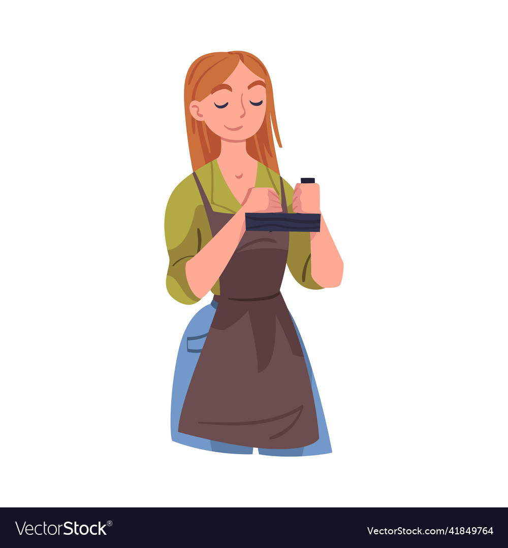 Young woman carpenter in apron with sharpener