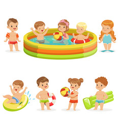 Small Children Having Fun In Water Of The Pool