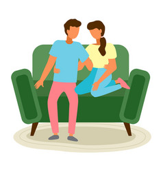 Young Family Couple Sits On The Green Sofa