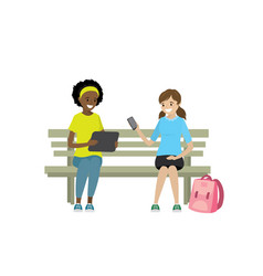 Two Teen Girls With Gadgets Are Sitting