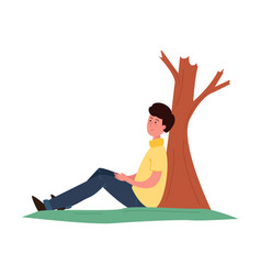 Young Man Sitting Under A Tree Relaxes