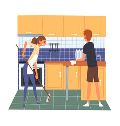 Husband And Wife Cleaning Kitchen Together Young