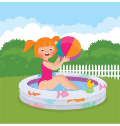 Little girl splashing in the summer inflatable poo