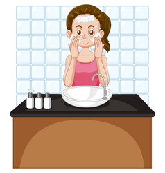 A Female Teen Cleaning Face At The Sink