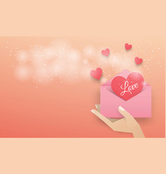 Hand Holding A Pink Envelope With A Dark Red