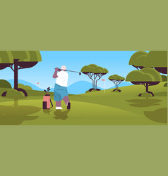 Senior Woman Playing Golf On Green Course