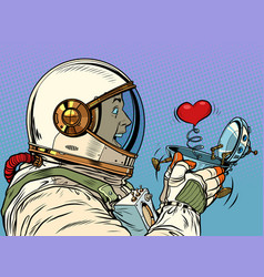 Surprised Male Astronaut Looks At A Red Heart