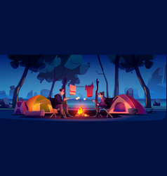 Couple In Camp With Tent And Campfire At Night