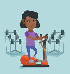 African Woman Exercising On Elliptical Trainer