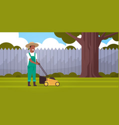 Man Gardener Cutting Green Grass With Lawn Mover