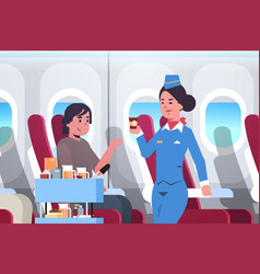 Flight Attendant Serving Drinks To Passenger