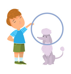 Boy Training His Grey Poodle Dog With Hoop