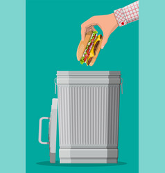 Hand Throwing Away Burger To Trash Bin