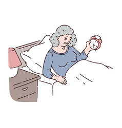 Tired Senior Woman Lie In Bed And Hold Alarm Clock