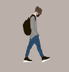 A Guy In Jeans And Gray Sweatshirt With Backpa