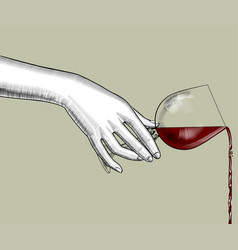 Female Hand Pours Wine From A Glass