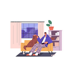 Man And Dog Relaxing At Home Sitting On Sofa