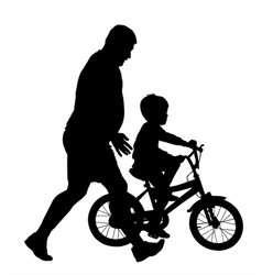 Father Teaching His Son Riding A Bicycle