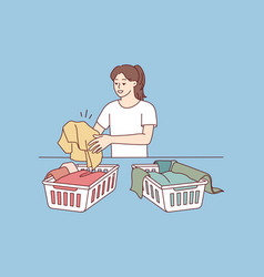 Woman Sorting Laundry In Baskets