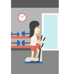 Woman Exercising On Elliptical Trainer