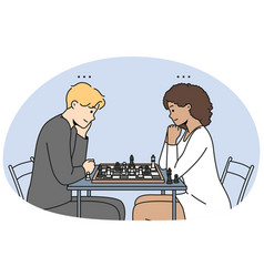 Couple Sit At Table Playing Chess