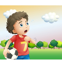 A Boy Holding Soccer Ball Wearing Red Shirt