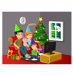 A Happy Family Watching Television In Christmas