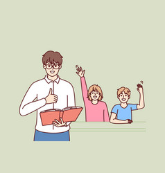 Man Teacher With Textbook Stands Near Students