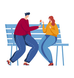 Man Giving A Flower To A Woman On A Park Bench