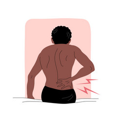 A Man With Back Pain Sits On Bed