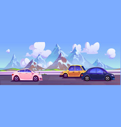 Cars Driving On Road With Mountains In Horizon