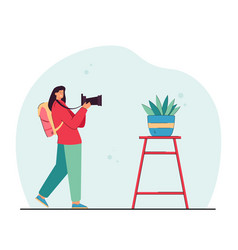 Female Photographer Taking Photo Of Potted Plant