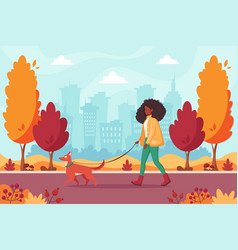 Black Woman Walking With Dog In Autumn Park