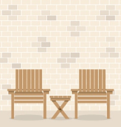 Wooden Garden Chairs With Table In Front Of Bricks