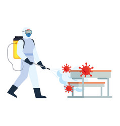 Man With Protective Suit Spraying School Tables