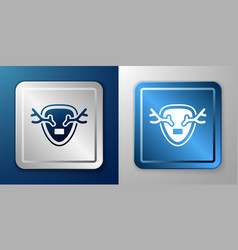 White Deer Antlers On Shield Icon Isolated On Blue