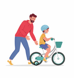 Caring Dad Teaching Little Son In Helmet To Ride