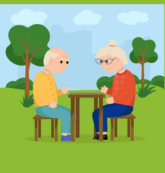 Grandparents Playing Checkers In The Park Elderly