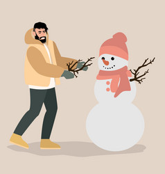 Young Man Having Fun Making Snowman