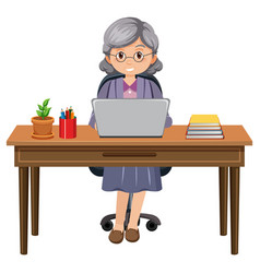 Senior Woman Sitting In Front Of Laptop