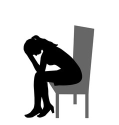 Sad Woman Sitting On A Chair And Holding Her Head